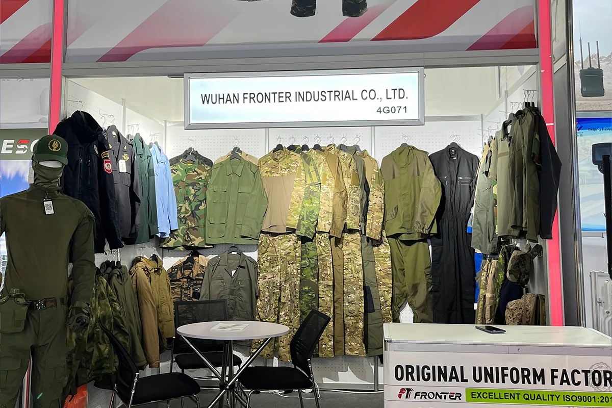Fronter 2023 Milipol Paris booth showcasing tactical uniforms, camouflage apparel, and protective clothing