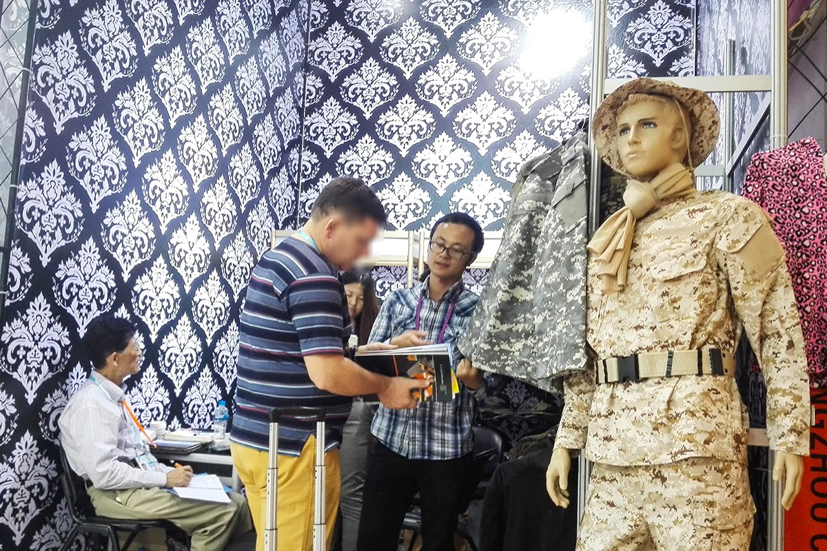 WHFronter 2014 exhibition booth – tactical uniform mannequin display and product discussion with buyers