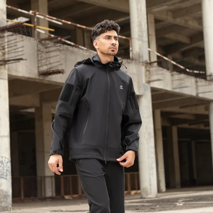 Sleek black fall jacket with hood, windproof softshell design. Ideal for autumn weather, outdoor activities, and tactical lifestyle.