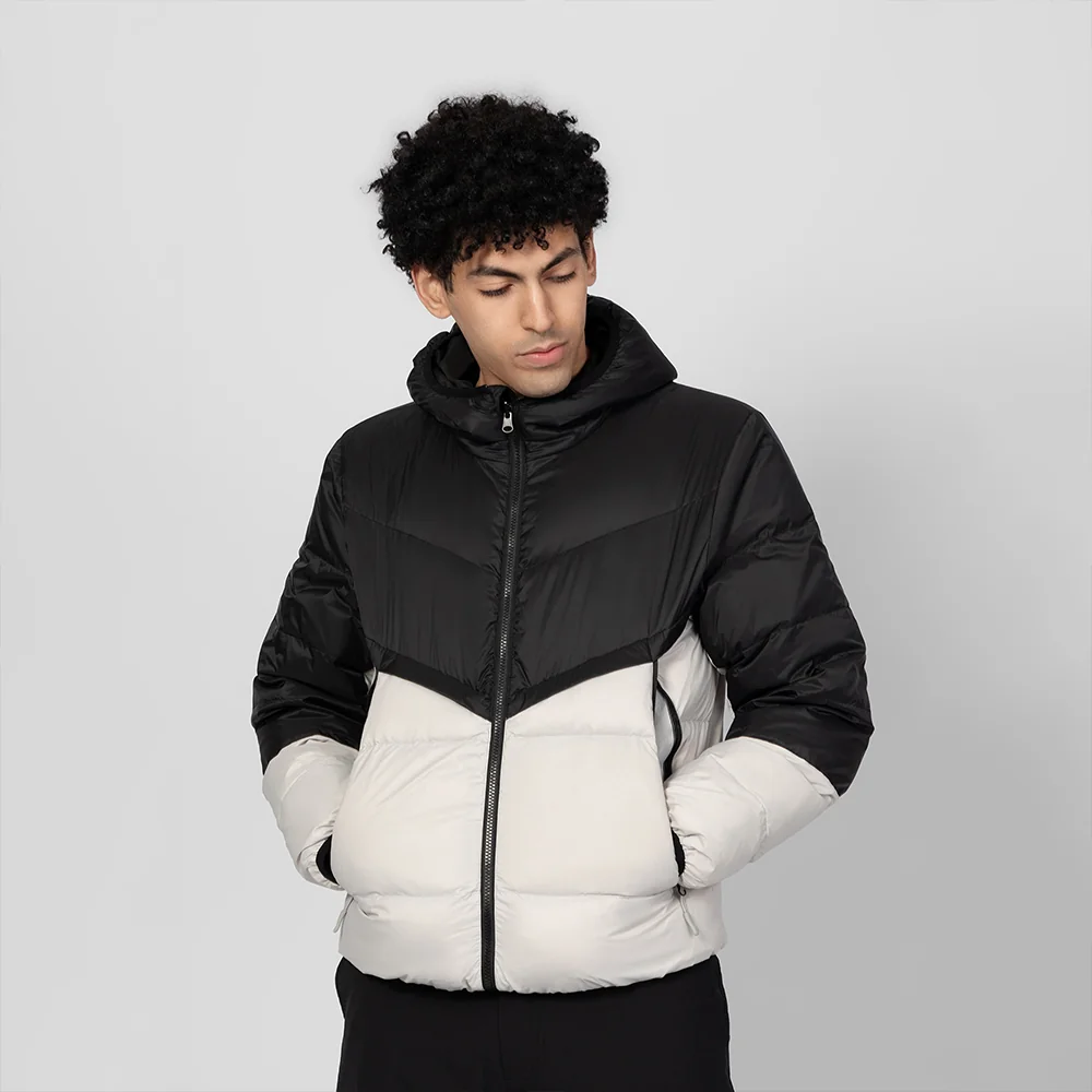 Front view of men’s lightweight down jacket in black and white color block. Warm, soft, and ideal for casual winter wear.