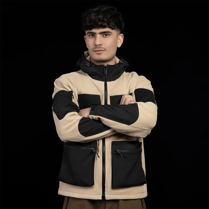 Front view of men’s khaki and black polar fleece jacket. Multi-pocket design, soft fleece warmth, and windproof hood for outdoor comfort.