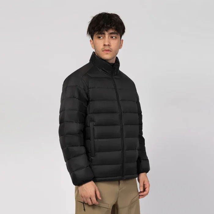Men’s black lightweight quilted jacket with stand collar and front zip. Compact design for travel, layering, or outdoor wear.