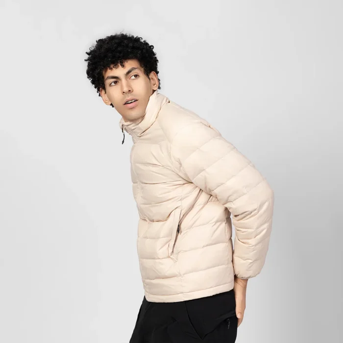 Beige lightweight quilted jacket for men, featuring soft padding and a slim fit. Ideal as an inner layer or casual outerwear.