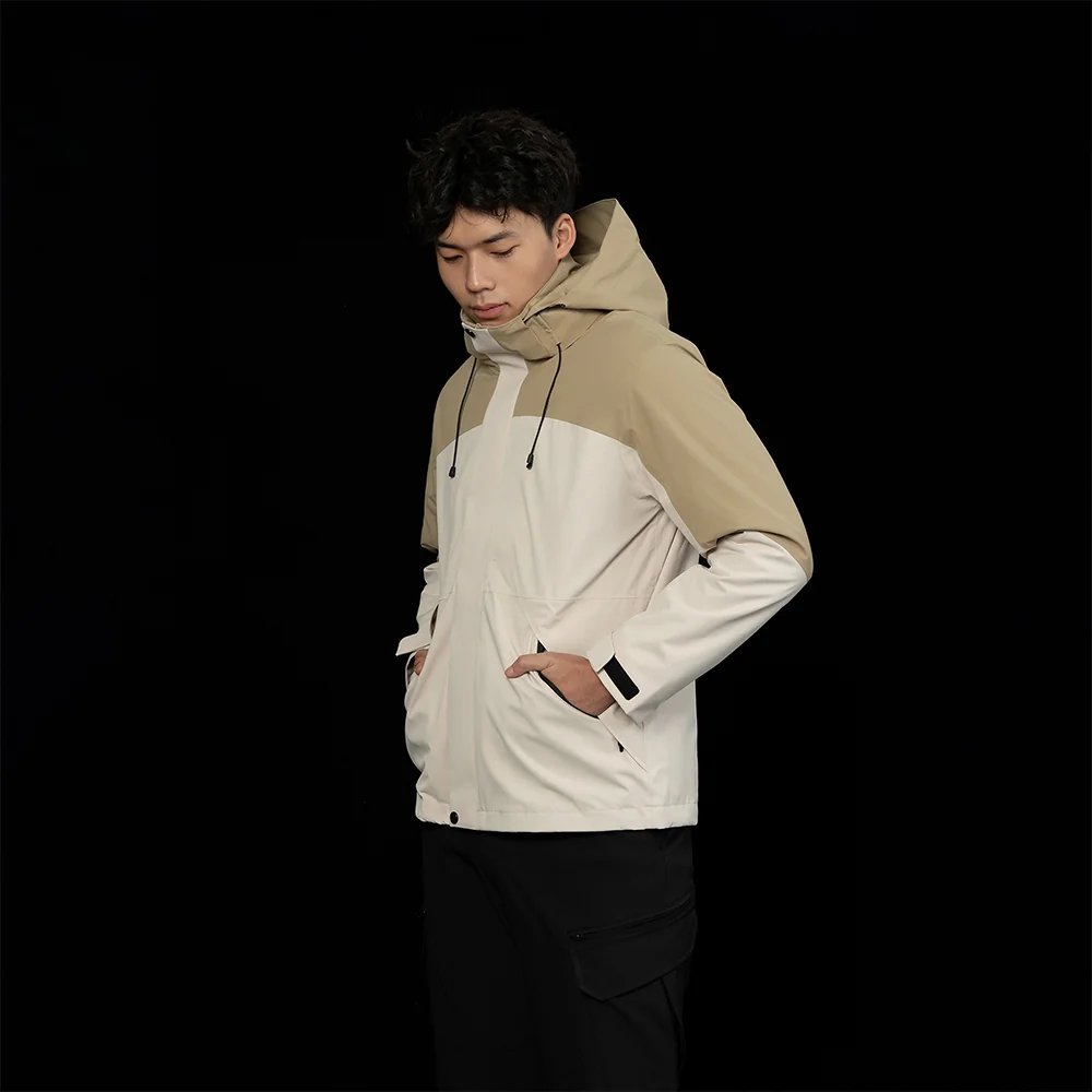 Beige and khaki 3 in 1 men’s waterproof jacket modeled with hood and zip-out fleece. Perfect for hiking, trekking, and travel.