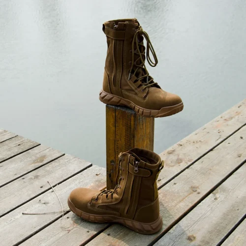 Outdoor display of tan military boots near water, showcasing rugged build, lace-up system, and tactical performance style.