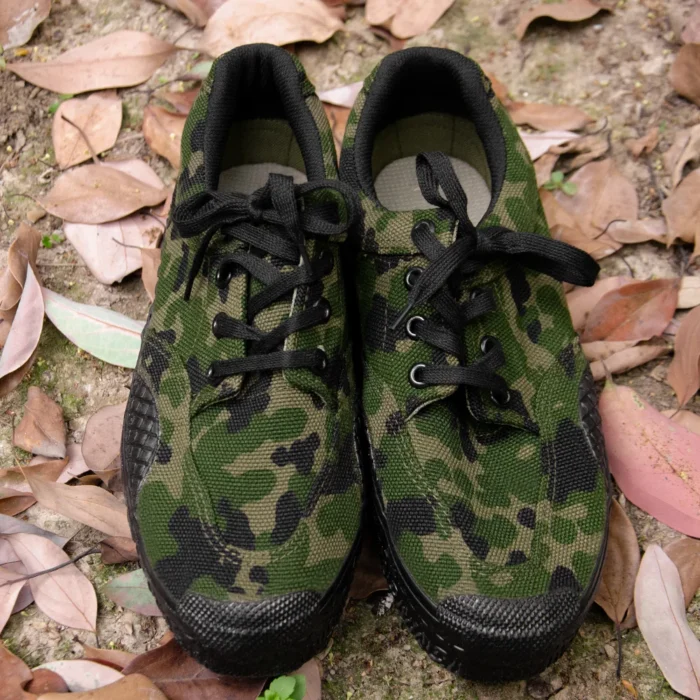 Front view of a pair of camouflage training shoes with breathable fabric and durable outsole for field training or outdoor work.