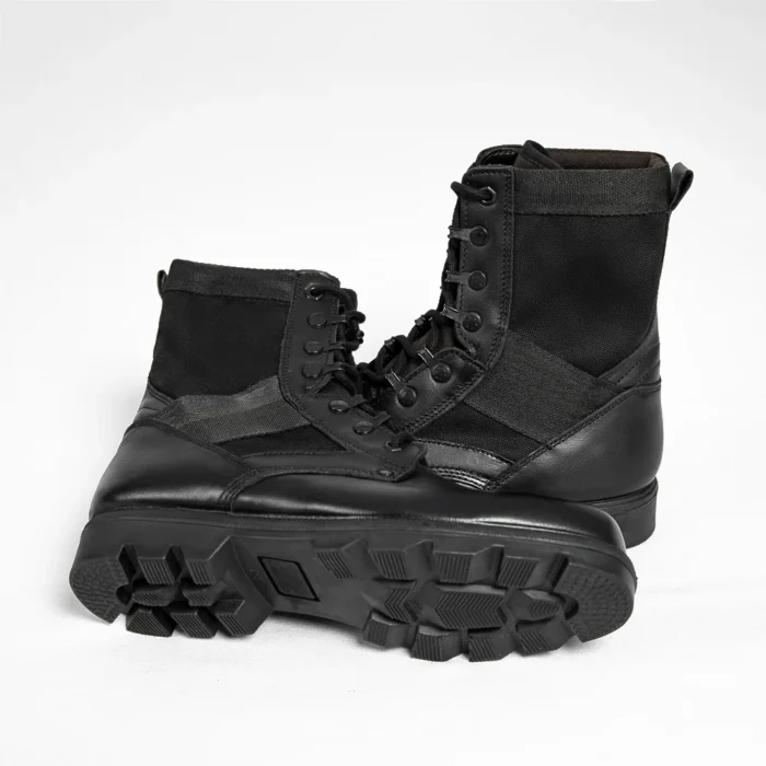 Pair of black leather military boots featuring rugged outsole, reinforced stitching, and breathable canvas panels for field durability.