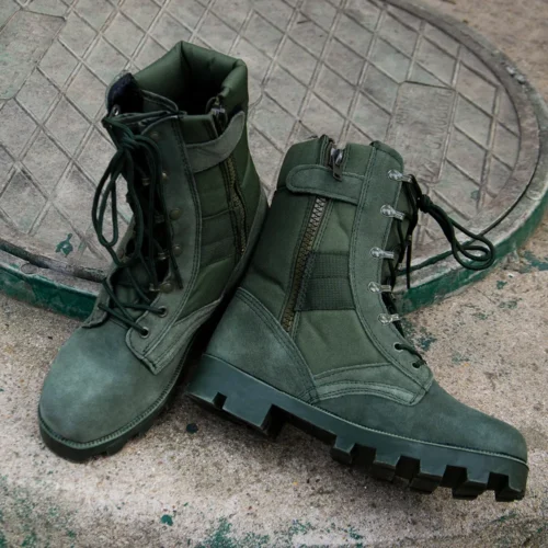 Pair of green military boots shoes displayed outdoors, showcasing rugged sole grip and ankle protection suitable for combat missions.