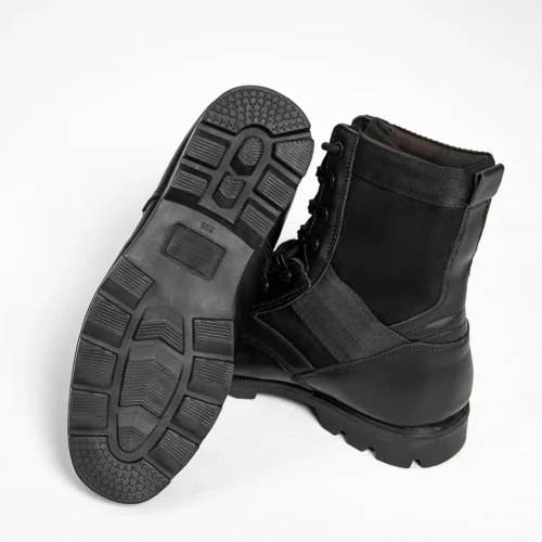 Black leather military boots with durable rubber sole and lace-up design, offering reliable traction and protection for tactical missions.