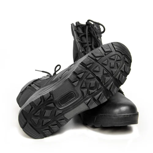 Bottom view of leather combat boots showing rugged anti-slip rubber sole for enhanced grip and stability on rough terrain.