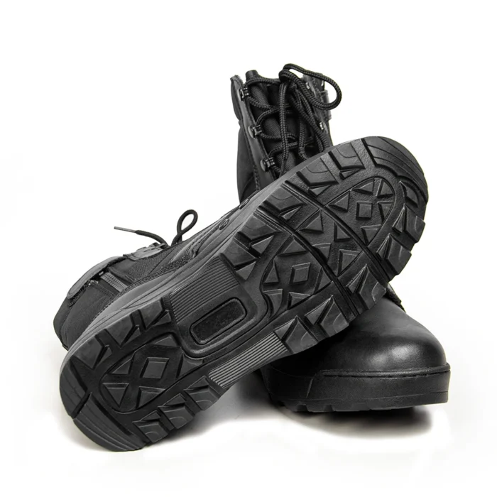 Bottom view of leather combat boots showing rugged anti-slip rubber sole for enhanced grip and stability on rough terrain.