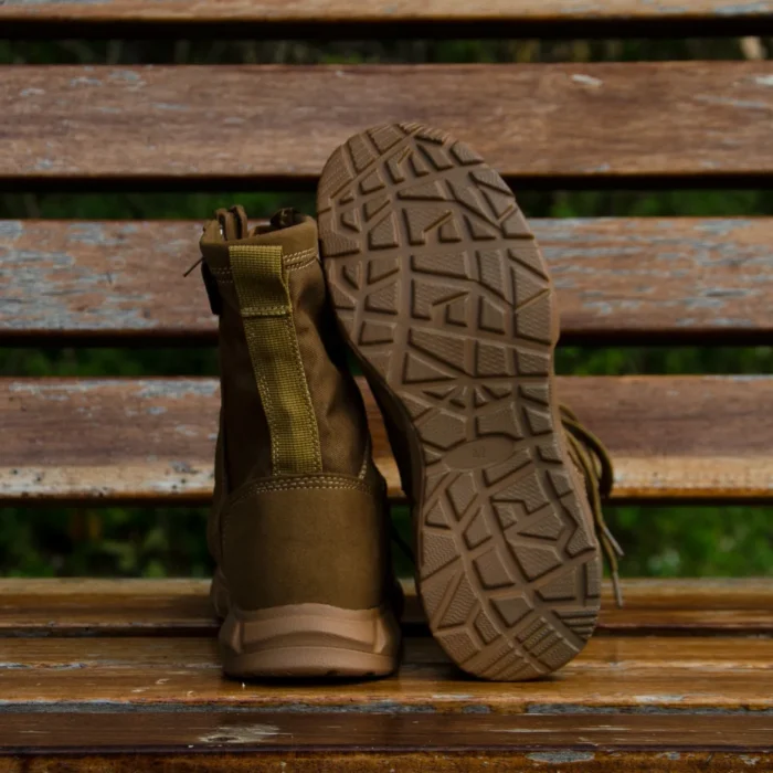Back and outsole view of tan tactical boots highlighting traction pattern and strong heel construction for stability on rough terrain.