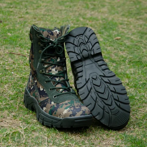 Camouflage army combat boots with rugged black outsole and green upper, designed for tactical missions and field operations.