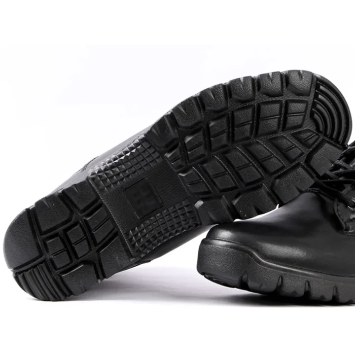 Close-up of black combat boots outsole featuring deep tread pattern and high-grip rubber design for stability and slip resistance.