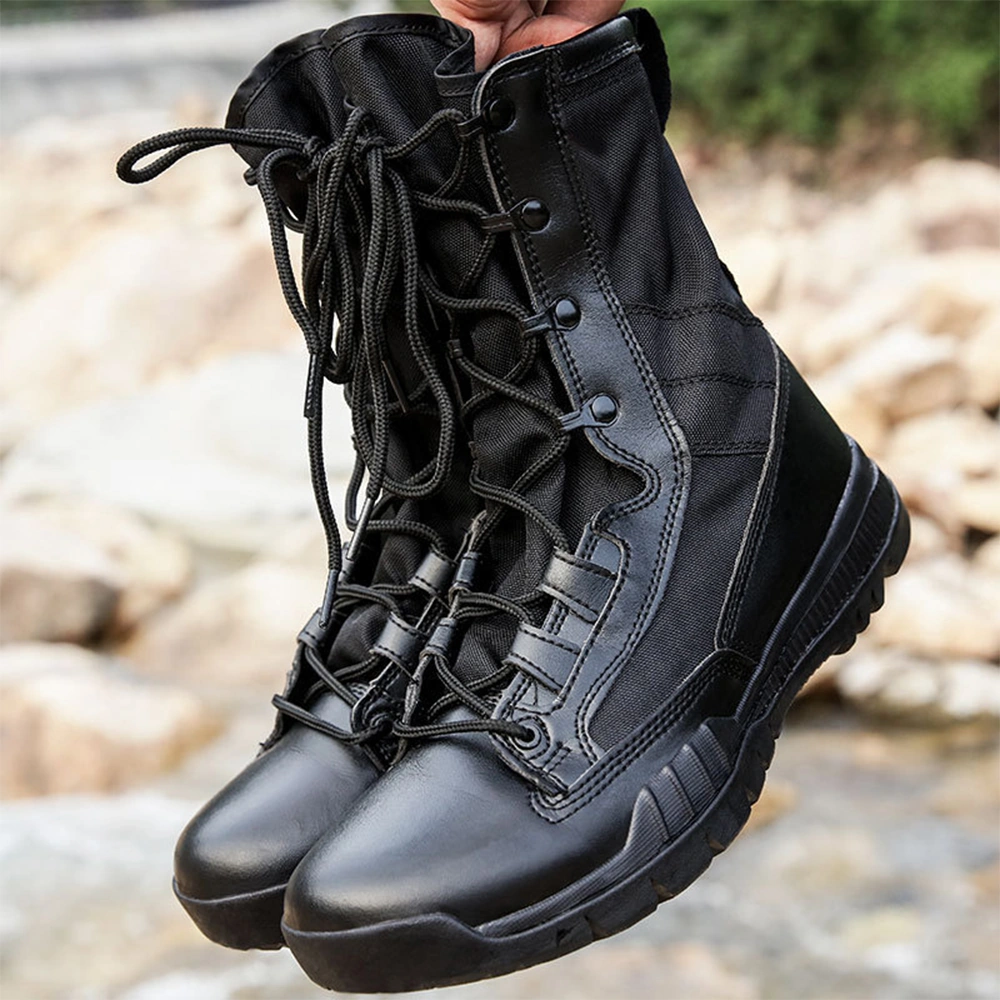 Pair of black combat boots held by hand, featuring abrasion-resistant leather and high ankle support for military professionals.