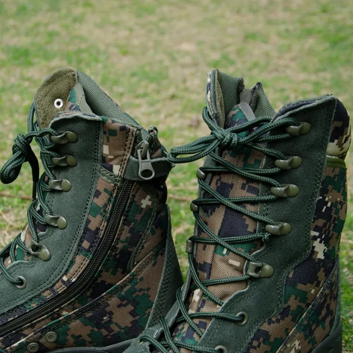 Close-up of camouflage army combat boots with sturdy lace hooks, YKK side zipper, and reinforced fabric stitching for heavy-duty use.