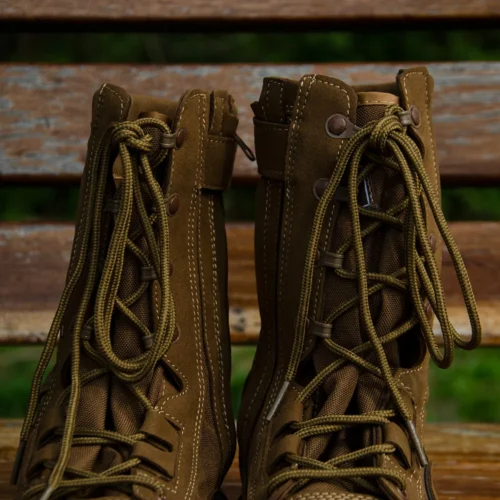 Close-up view of tan military boots showing durable stitching, strong laces, and breathable upper materials for reliable field use.