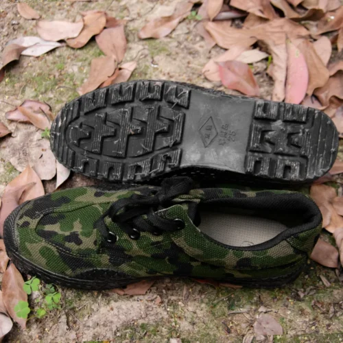 Bottom view of green camouflage training shoes showing deep tread rubber sole for superior traction on outdoor and rough surfaces.