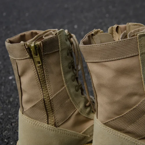 Close-up of army combat boots showing YKK zipper, lace hooks, and reinforced stitching for enhanced durability and comfort.