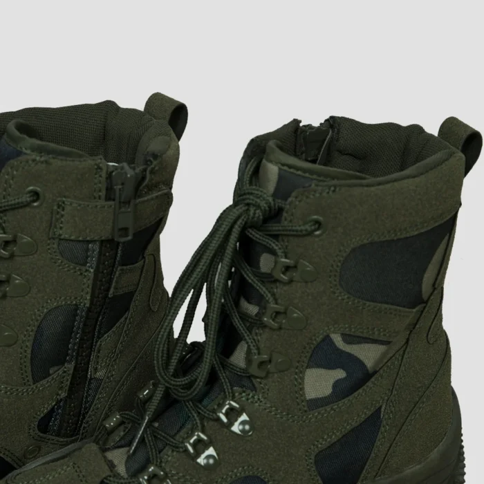Close-up image of lace up combat boots showing strong lacing system, side zipper, and padded collar for enhanced comfort and fit.
