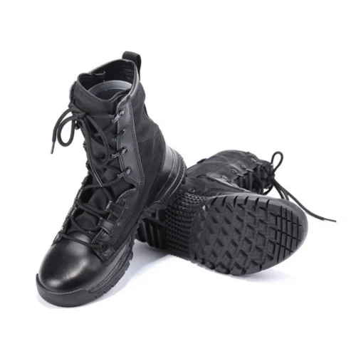 Bottom view of black combat boots with deep tread pattern for superior traction and stability on rugged outdoor surfaces.