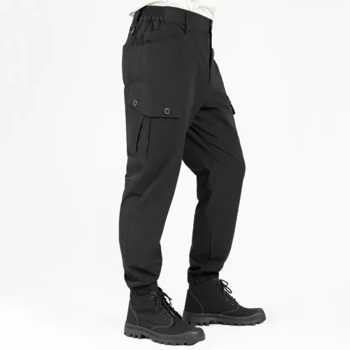 Side view of lightweight tactical pants in black color, highlighting ergonomic cut, flexible fabric and streamlined cargo pocket layout for tactical and work environments.