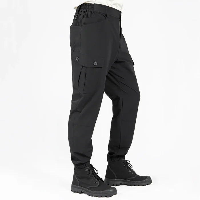 Side view of lightweight tactical pants in black color, highlighting ergonomic cut, flexible fabric and streamlined cargo pocket layout for tactical and work environments.