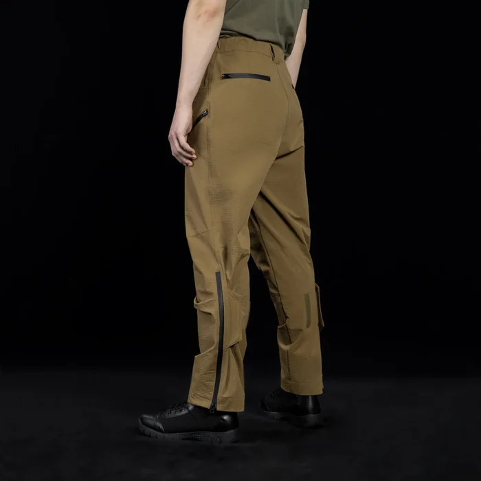 Angled rear side view of outdoor cargo pants showcasing tactical zipper details, reinforced panels, and a performance-driven fit for long-term outdoor wear.