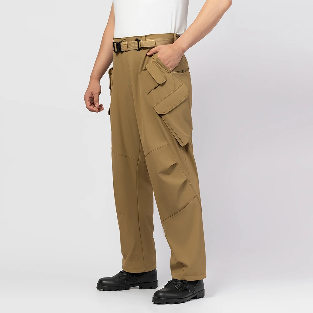 Side view of outdoor cargo pants showing ergonomic cut, utility pocket layout, and durable fabric design for outdoor work, tactical use, and wholesale supply.