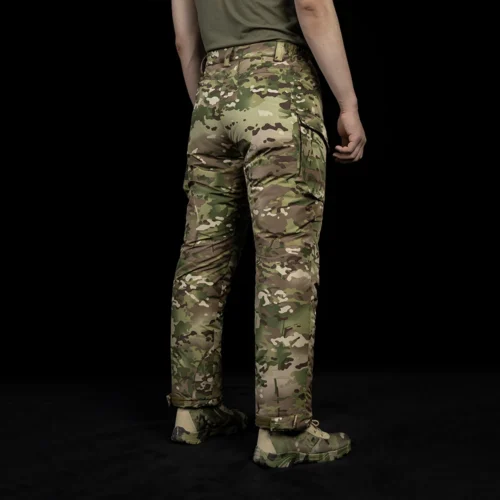 Rear angled view of cold weather tactical pants featuring insulated camouflage fabric, articulated fit, and durable construction for cold weather field deployment.