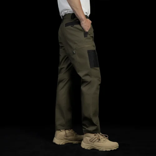 Back side view of tactical cargo pants on model, emphasizing mobility-focused tailoring, reinforced areas, and practical rear pocket placement.