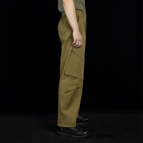 Angled side view of outdoor cargo pants showing reinforced panel design and flexible tailoring, suitable for hiking, camping, and outdoor tactical applications.