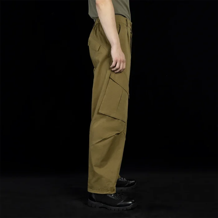 Angled side view of outdoor cargo pants showing reinforced panel design and flexible tailoring, suitable for hiking, camping, and outdoor tactical applications.