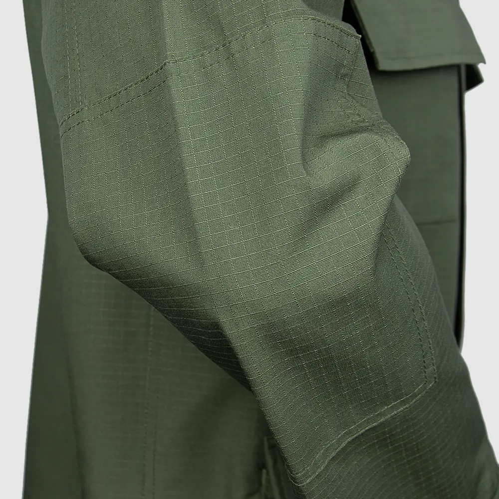 Elbow area reinforcement detail for BDU-style uniform manufacturing. Options include added layers, seam finishing, and durability-focused construction for program supply.