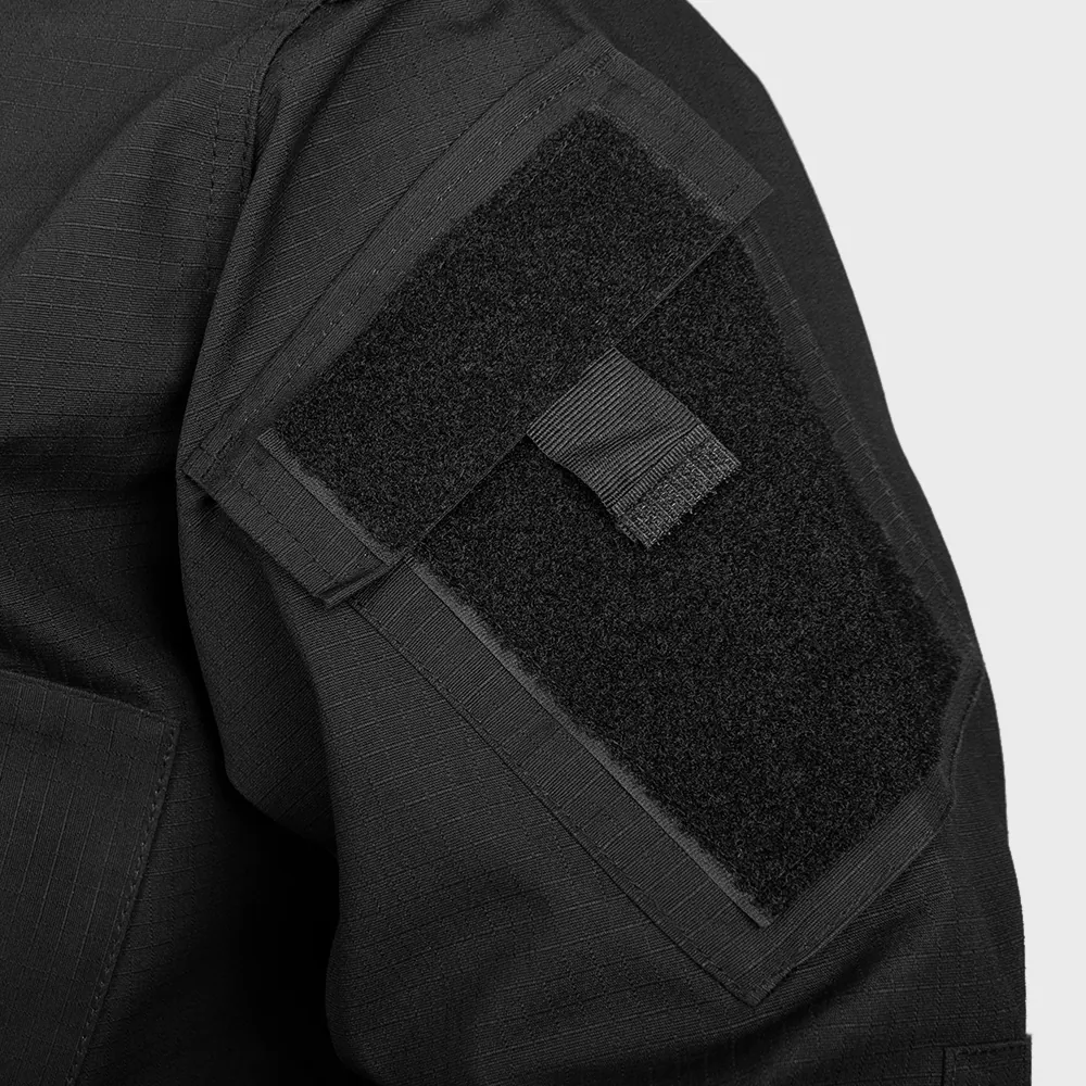 Close-up of sleeve hook-and-loop ID panel on a black tactical duty uniform. Supports OEM customization for patch sizing, placement, attachment method, and stitching reinforcement.