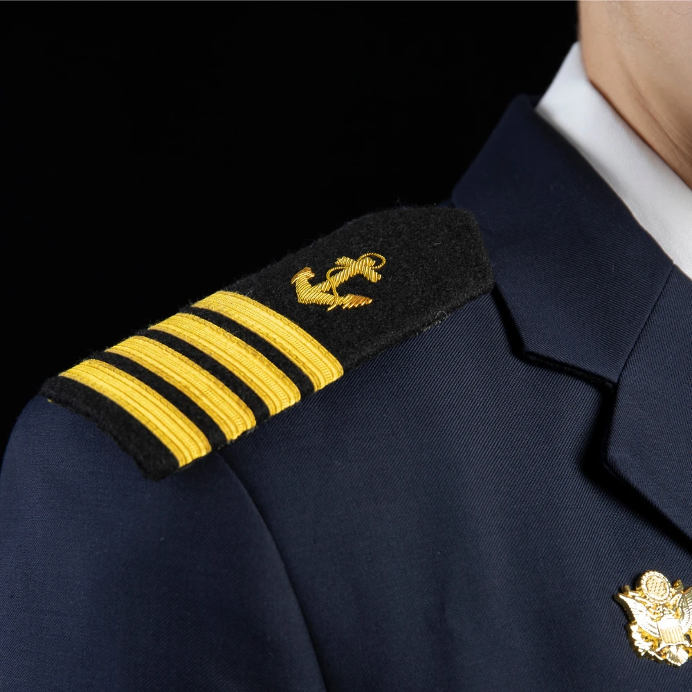 Epaulette and rank trim detail for officer dress uniform manufacturing. Options may include embroidery technique, trim materials, and secure attachment for repeated wear.