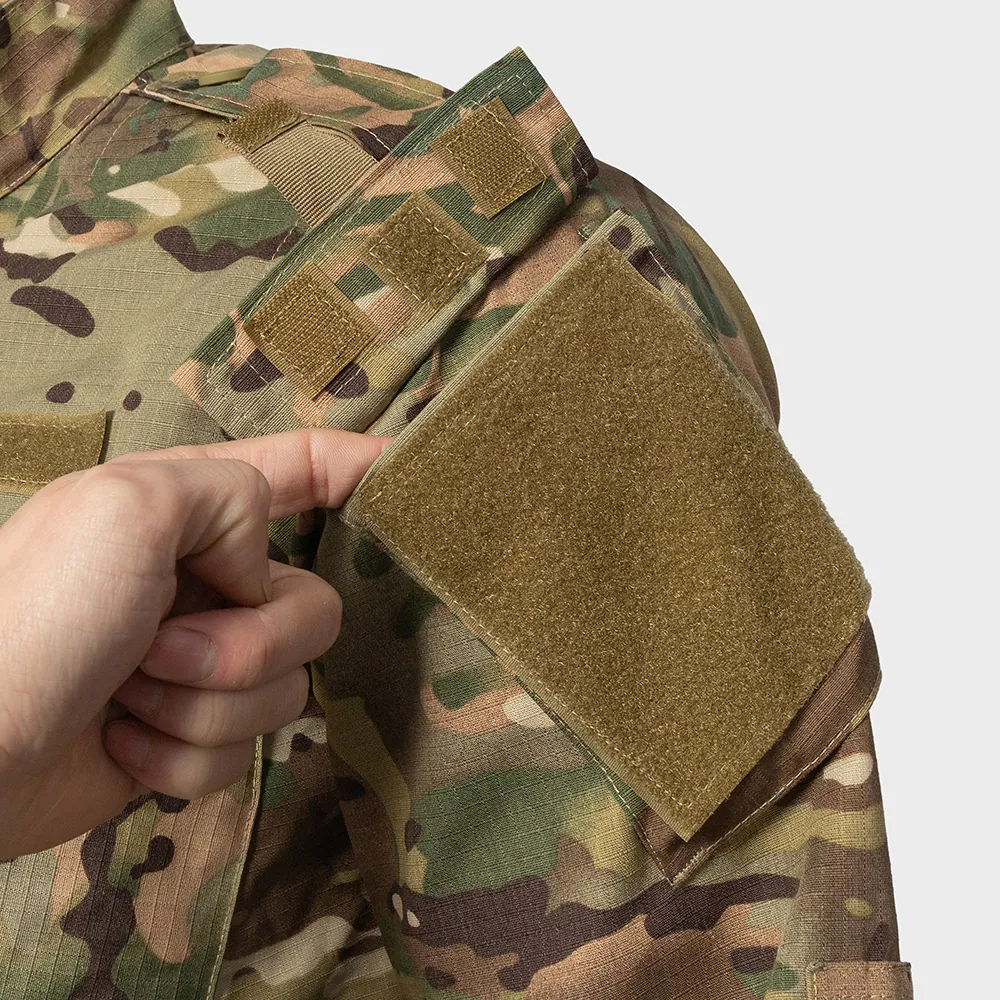 Close-up of sleeve hook-and-loop patch panel and ID placement for ACU-style uniform manufacturing. Reference only—custom branding, panel sizing, and stitching options available for program orders.