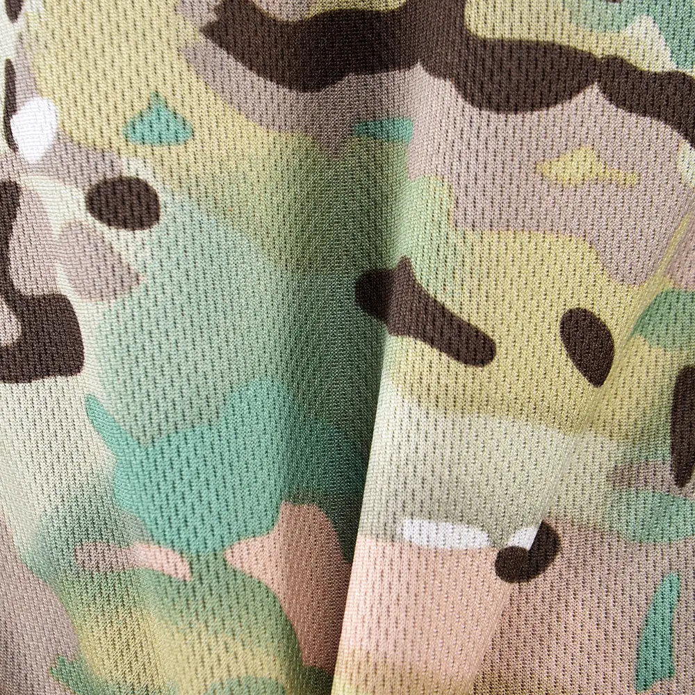 Macro texture of breathable mesh fabric used in quick-dry camouflage T-shirts, highlighting ventilation holes and lightweight structure for hot-climate uniform applications.